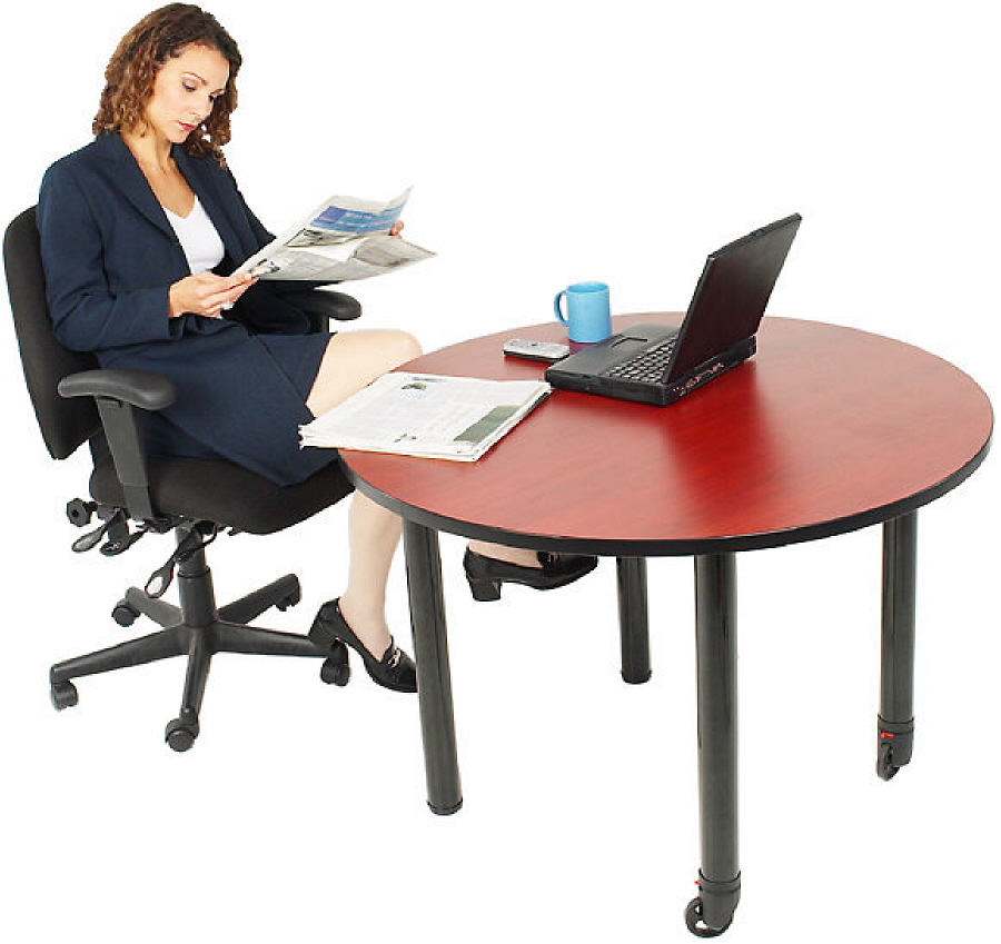 Businesswoman reading newspaper at her desk 1